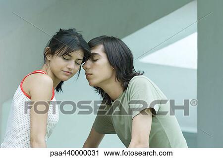 Young couple with heads together, eyes shut View Large Photo Image Stock Image - Young couple with heads together, eyes shut. Fotosearch