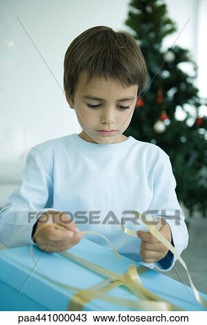 Boy opening Christmas present View Large Photo Image Stock Image - Boy opening Christmas present. Fotosearch