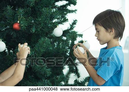 Children decorating Christmas tree View Large Photo Image Stock Photo - Children decorating Christmas tree. Fotosearch