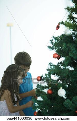Children decorating Christmas tree View Large Photo Image Stock Photograph - Children decorating Christmas tree. Fotosearch