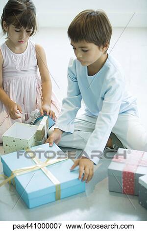 Stock Photo - Children reaching for Christmas presents. Fotosearch