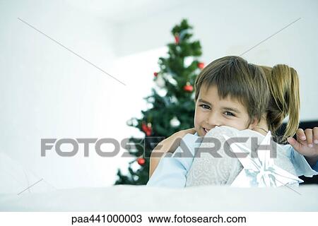 Mother hugging son, Christmas tree in background View Large Photo Image Stock Image - Mother hugging son, Christmas tree in background. Fotosearch