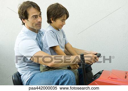 Father and son on riding lawn mower together View Large Photo Image Stock Photography - Father and son on riding lawn mower together. Fotosearch