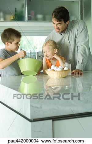 Picture - Father cooking with son and daughter. Fotosearch