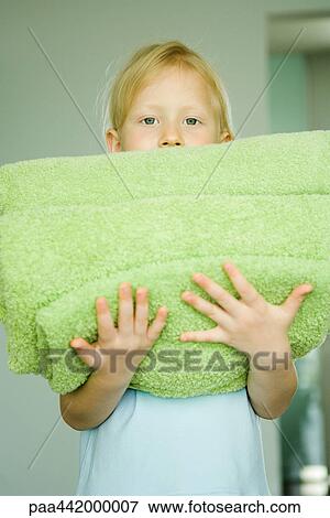 Girl holding stack of folded towels View Large Photo Image Stock Photo - Girl holding stack of folded towels. Fotosearch