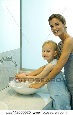 Mother and daughter washing hands together View Large Photo Image Stock Image - Mother and daughter washing hands together. Fotosearch