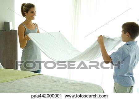 Mother and son folding sheet together View Large Photo Image Stock Image - Mother and son folding sheet together. Fotosearch