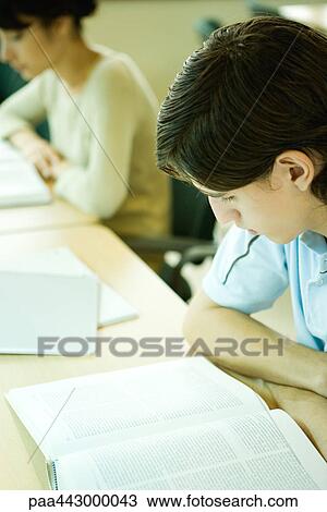 College students sitting at table in library, studying View Large Photo Image Stock Image - College students sitting at table in library, studying. Fotosearch