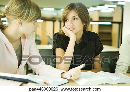 College students sitting at table in library, talking View Large Photo Image Stock Photograph - College students sitting at table in library, talking. Fotosearch