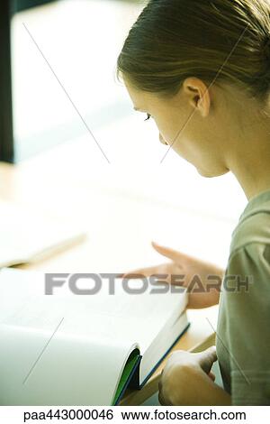 Female college student sitting at table in library, studying View Large Photo Image Stock Photograph - Female college student sitting at table in library, studying. Fotosearch