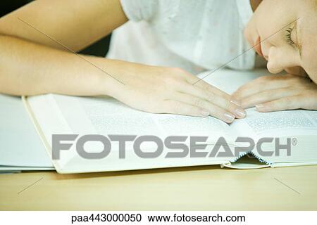 Female college student sitting with head on book, close-up View Large Photo Image Stock Image - Female college student sitting with head on book, close-up. Fotosearch