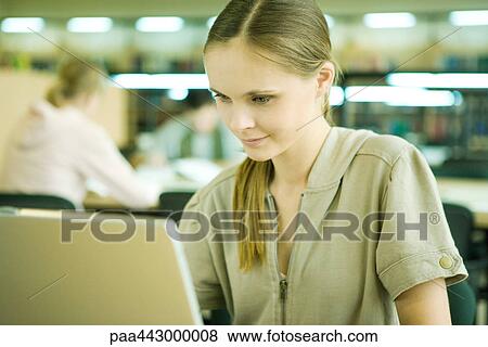 Stock Photo - Female college student using laptop. Fotosearch