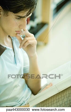 Male college student sitting in library, studying View Large Photo Image Stock Image - Male college student sitting in library, studying. Fotosearch