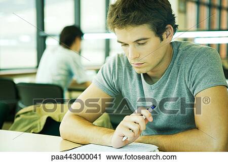 Male college student sitting in library, studying View Large Photo Image Stock Image - Male college student sitting in library, studying. Fotosearch
