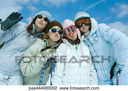 Four female friends dressed in ski clothing, puckering at camera, portrait View Large Photo Image Stock Image - Four female friends dressed in ski clothing, puckering at camera, portrait. Fotosearch