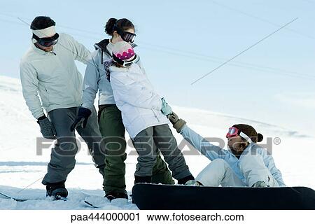 Girl sitting on ground, on snowboard, being pulled up by friends View Large Photo Image Stock Image - Girl sitting on ground, on snowboard, being pulled up by friends. Fotosearch