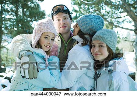 Stock Photo - Young friends wearing winter clothing, portrait. Fotosearch