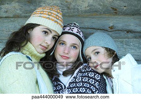 Young friends wearing winter clothing, portrait View Large Photo Image Stock Photo - Young friends wearing winter clothing, portrait. Fotosearch