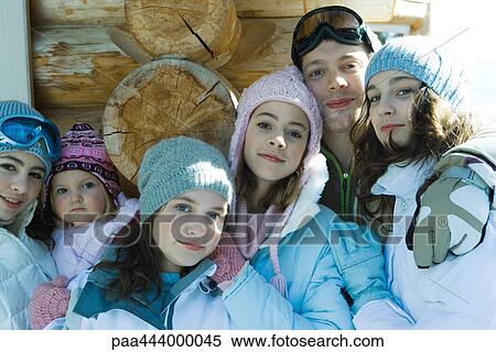 Young friends wearing winter clothing, portrait View Large Photo Image Stock Photography - Young friends wearing winter clothing, portrait. Fotosearch