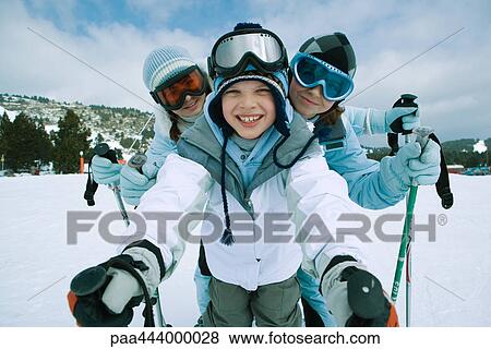 Young skiers standing on ski slope, portrait View Large Photo Image Stock Photo - Young skiers standing on ski slope, portrait. Fotosearch