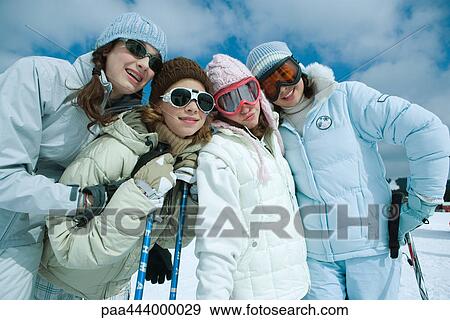 Young skiers standing on ski slope, portrait View Large Photo Image Stock Photo - Young skiers standing on ski slope, portrait . Fotosearch