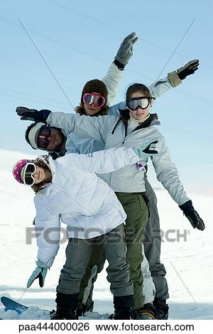 Young skiers standing on ski slope, full length portrait View Large Photo Image Stock Photograph - Young skiers standing on ski slope, full length portrait . Fotosearch