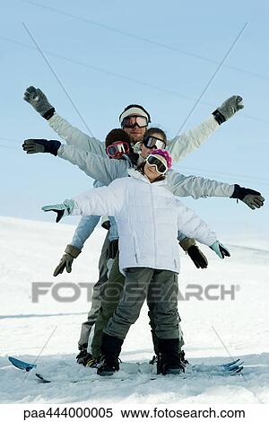 Young skiers with arms out, full length portrait View Large Photo Image Stock Photography - Young skiers with arms out, full length portrait. Fotosearch