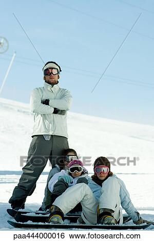 Stock Photograph - Young snowboarders on ski slope, full length portrait . Fotosearch