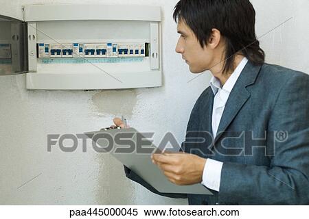 Man inspecting fuse box View Large Photo Image Stock Photography - Man inspecting fuse box. Fotosearch
