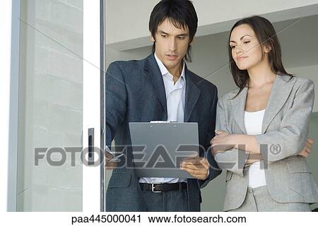 Young man with clipboard showing young woman sliding glass door View Large Photo Image Stock Image - Young man with clipboard showing young woman sliding glass door. Fotosearch
