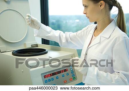 Young female researcher using centrifuge View Large Photo Image Stock Image - Young female researcher using centrifuge. Fotosearch