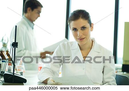 Stock Photography - Young female scientist working in lab, portrait. Fotosearch