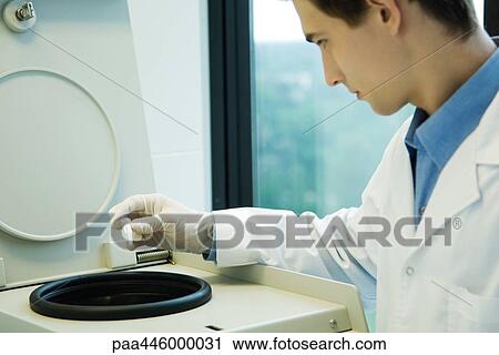 Young male researcher using centrifuge in lab View Large Photo Image Stock Image - Young male researcher using centrifuge in lab. Fotosearch