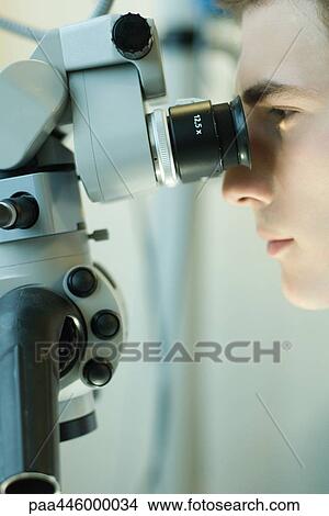 Young male scientist using microscope View Large Photo Image Picture - Young male scientist using microscope. Fotosearch