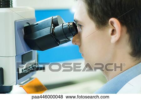 Young male scientist using microscope View Large Photo Image Stock Photo - Young male scientist using microscope. Fotosearch