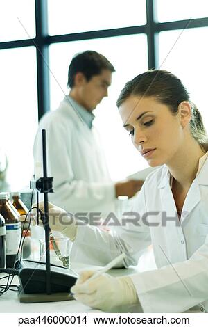 Picture - Young woman working in scientific laboratory. Fotosearch