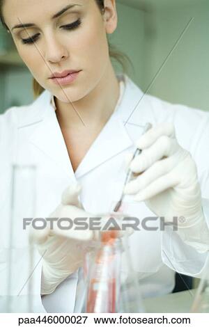 Stock Photo - Young woman working in scientific laboratory. Fotosearch