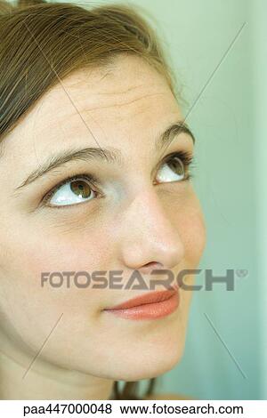 Young woman looking up, portrait, close-up View Large Photo Image Stock Photo - Young woman looking up, portrait, close-up. Fotosearch