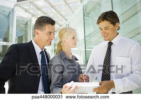 Business associates, man signing document held by woman View Large Photo Image Stock Image - Business associates, man signing document held by woman. Fotosearch