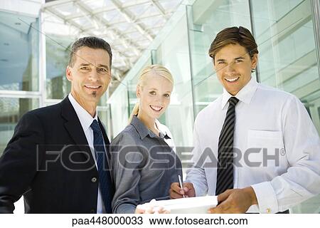 Business associates, man signing document held by woman View Large Photo Image Stock Image - Business associates, man signing document held by woman. Fotosearch