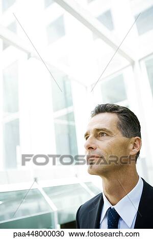 Stock Image - Businessman looking away, head and shoulders, portrait. Fotosearch