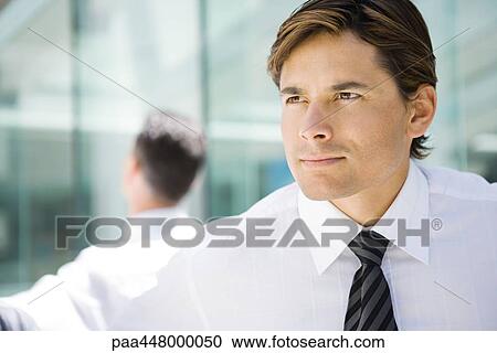 Stock Image - Businessman, looking out of frame, head and shoulders, portrait. Fotosearch