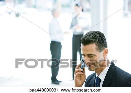 Businessman using cell phone View Large Photo Image Stock Photo - Businessman using cell phone. Fotosearch