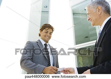 Businessmen exchanging business card View Large Photo Image Stock Photograph - Businessmen exchanging business card. Fotosearch
