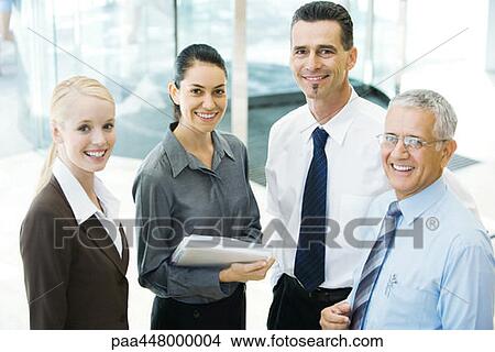 Four business associates, smiling at camera, portrait View Large Photo Image Picture - Four business associates, smiling at camera, portrait. Fotosearch