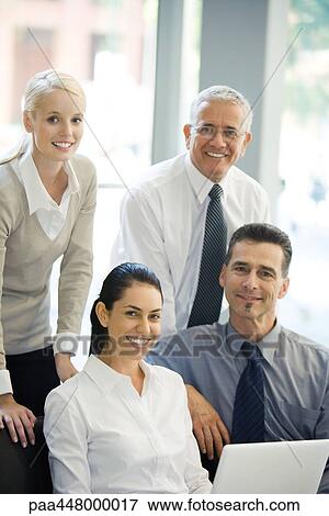 Four business associates, smiling at camera, portrait View Large Photo Image Stock Photo - Four business associates, smiling at camera, portrait. Fotosearch