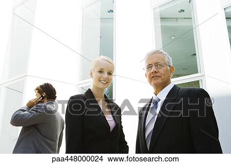 Mature businessman and young businesswoman, low angle view View Large Photo Image Picture - Mature businessman and young businesswoman, low angle view. Fotosearch