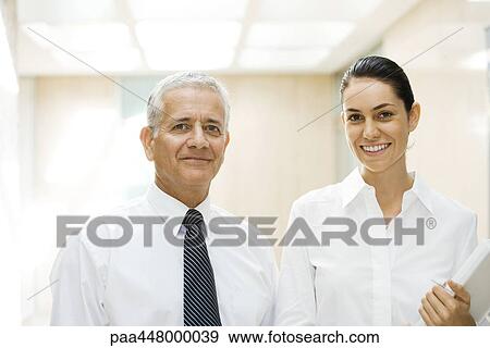 Mature businessman and young businesswoman, smiling at camera, portrait View Large Photo Image Stock Photo - Mature businessman and young businesswoman, smiling at camera, portrait. Fotosearch