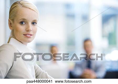 Young businesswoman, associates in blurred background, portrait View Large Photo Image Stock Image - Young businesswoman, associates in blurred background, portrait. Fotosearch