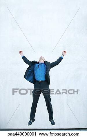 Businessman jumping in air, full length View Large Photo Image Stock Image - Businessman jumping in air, full length. Fotosearch